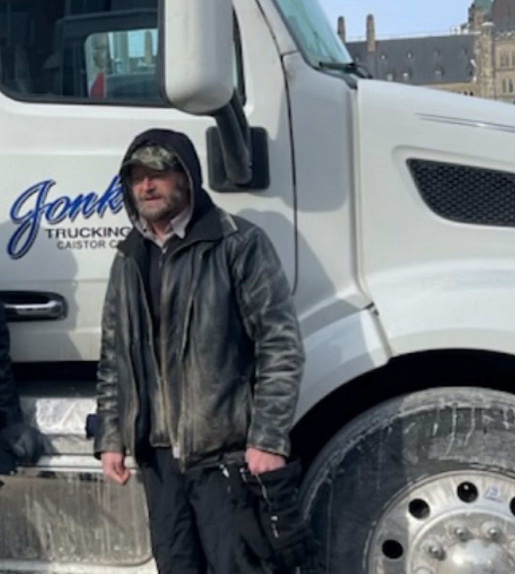 Image of Harold Jonker standing beside his semi truck